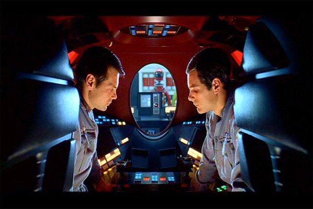 Two astronauts talking, with their mouths visible.