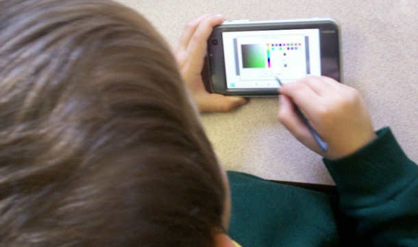 child using a smartphone with a stylus