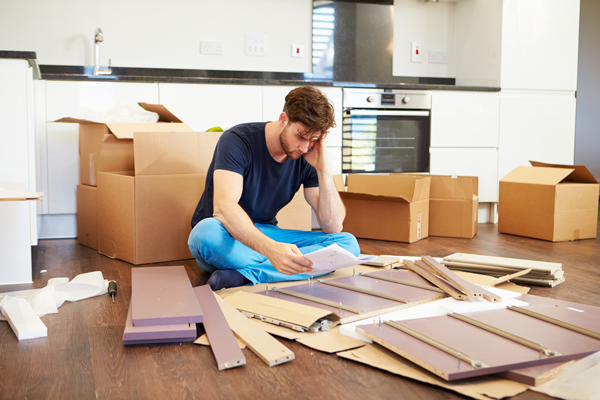 A man reading assembly instructions.