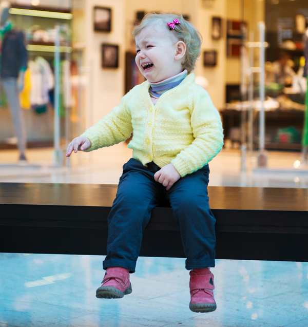 A crying child in a store.